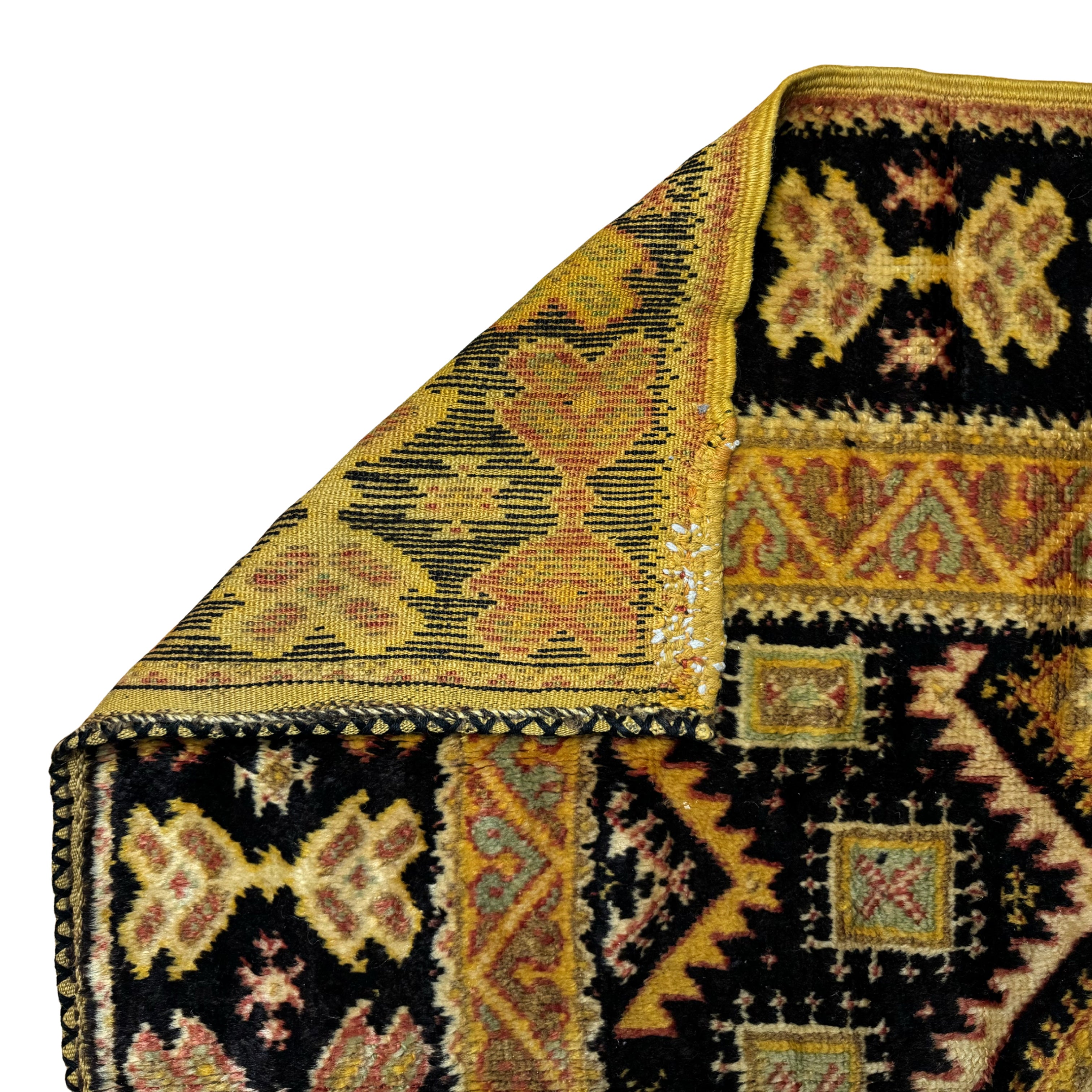 Close-up of a patterned rug with geometric designs on a white background