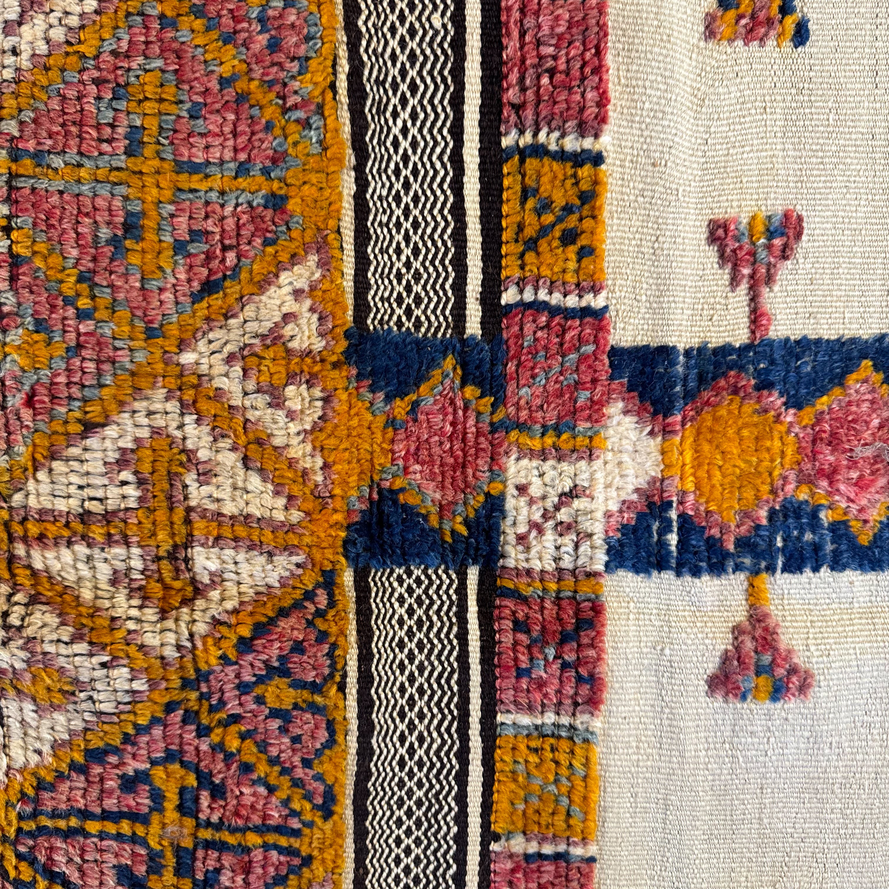 Close-up of a colorful woven textile with geometric patterns