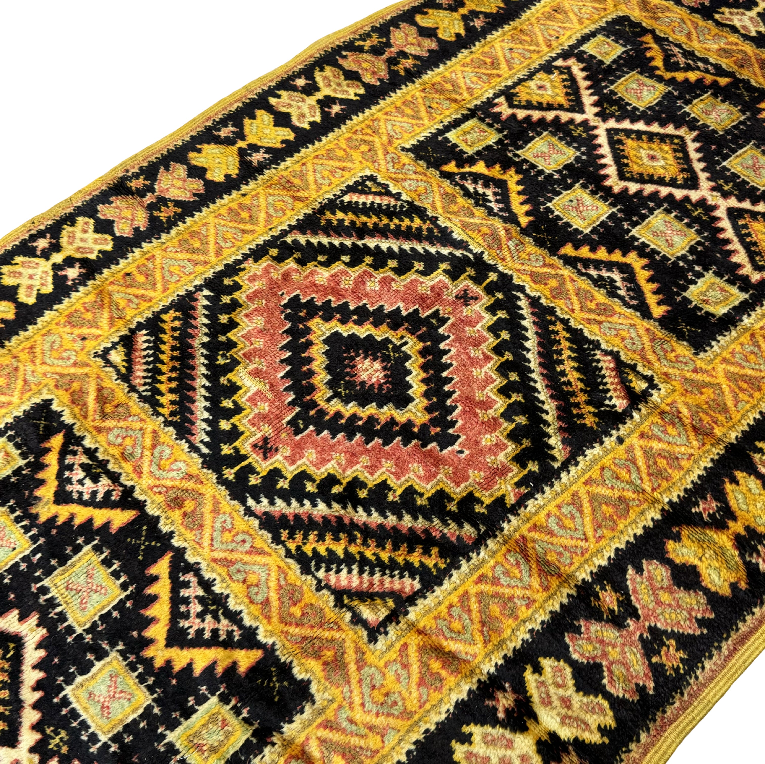 Close-up of a intricately patterned rug with geometric design
