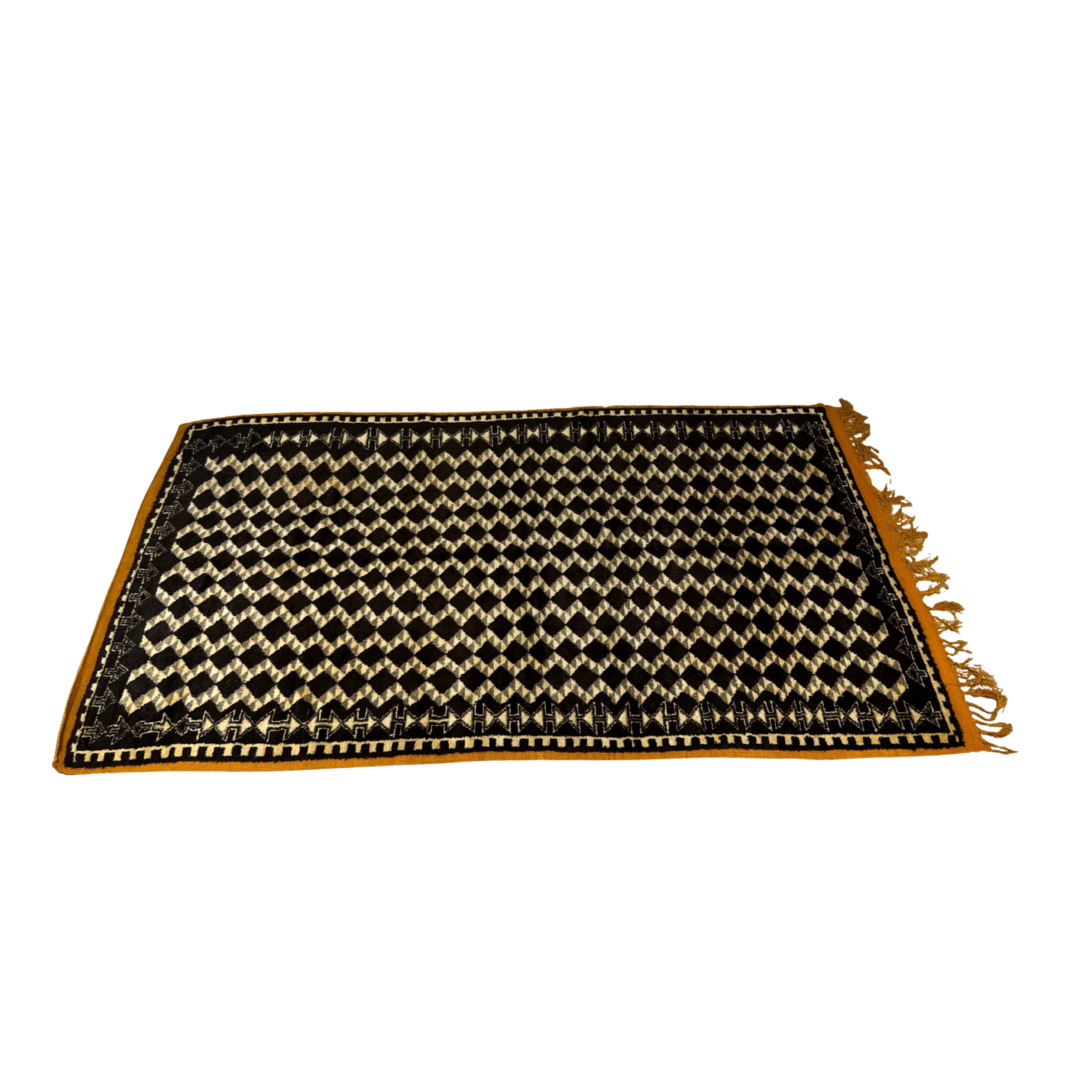 Black and gold woven mat with fringed edges on a white background