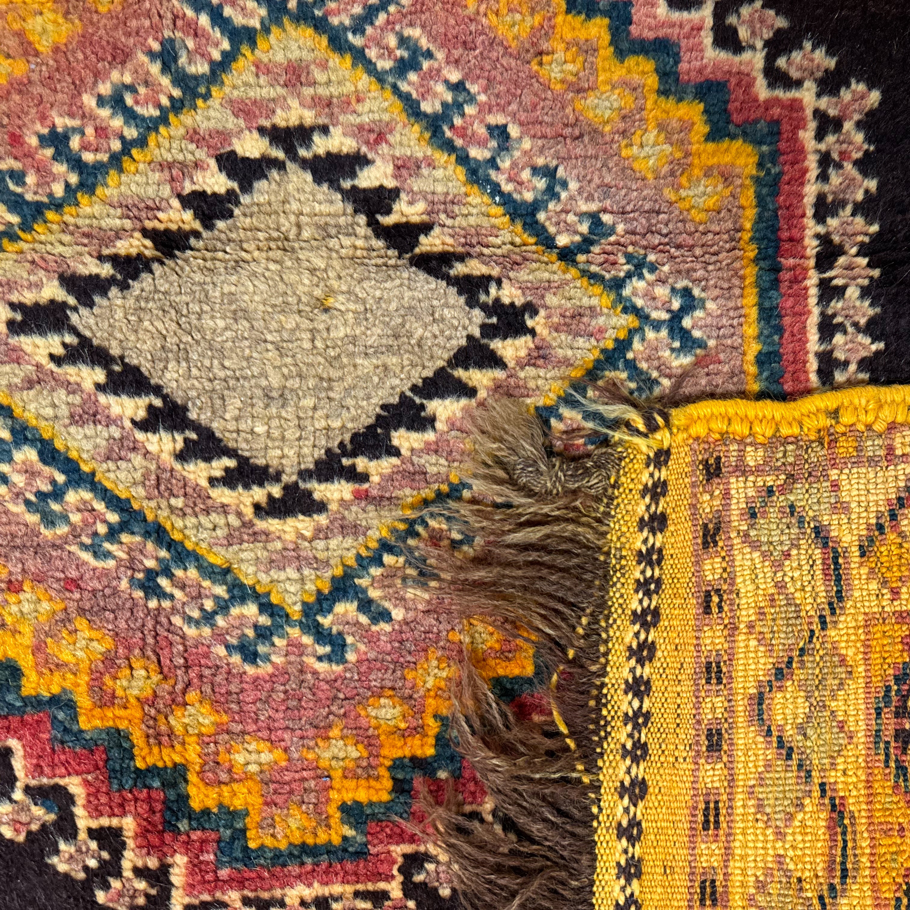 Close-up of a colorful patterned rug with intricate designs.